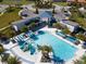 Community pool area with lush landscaping, lounge chairs, and a splash zone for Gathering fun at 2613 Santosh Cv, Kissimmee, FL 34746