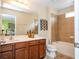 Well-lit bathroom with a double vanity, large mirror, and a tiled shower and tub combo, perfect for relaxation at 2613 Santosh Cv, Kissimmee, FL 34746