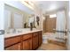 Full bathroom with a vanity, commode, and tile-surround bath and shower at 2613 Santosh Cv, Kissimmee, FL 34746