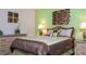 Serene bedroom showcasing a comfortable bed, matching nightstands with lamps, and soft, neutral-colored walls at 2613 Santosh Cv, Kissimmee, FL 34746
