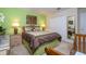 Bright bedroom features a comfortable bed, matching nightstands with lamps, a closet and an en suite at 2613 Santosh Cv, Kissimmee, FL 34746