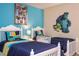 The bedroom with two white twin beds, has a fun Monster's Inc theme at 2613 Santosh Cv, Kissimmee, FL 34746