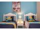 The bedroom has two white twin beds, a nightstand, and a whimsical Monster's Inc theme at 2613 Santosh Cv, Kissimmee, FL 34746