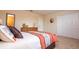 Comfortable bedroom featuring neutral colors and a cozy queen bed with an en suite at 2613 Santosh Cv, Kissimmee, FL 34746
