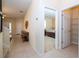 Bright entryway featuring tile floors, neutral walls, and a view into the adjacent bedroom and pantry at 2613 Santosh Cv, Kissimmee, FL 34746