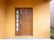 View of front door with sidelight on a yellow home exterior at 2613 Santosh Cv, Kissimmee, FL 34746