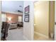 Hallway leading to powder room and living room with neutral walls and tiled flooring at 2613 Santosh Cv, Kissimmee, FL 34746