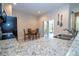 Kitchen with granite countertops, stainless steel sink, and a cozy breakfast nook with access to the outdoors at 2613 Santosh Cv, Kissimmee, FL 34746