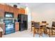 Well-equipped kitchen with stainless steel appliances, dark cabinets, and a cozy dining area at 2613 Santosh Cv, Kissimmee, FL 34746