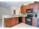 Modern kitchen featuring stainless appliances, granite countertops, and tiled backsplash at 2613 Santosh Cv, Kissimmee, FL 34746