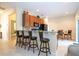 Kitchen bar and dining area with wood cabinets, granite countertops, and modern appliances at 2613 Santosh Cv, Kissimmee, FL 34746
