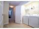 Convenient laundry room with a washer, dryer, and shelving for organized storage at 2613 Santosh Cv, Kissimmee, FL 34746