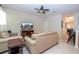 Comfortable living room featuring neutral-toned furniture, tile flooring, and a ceiling fan at 2613 Santosh Cv, Kissimmee, FL 34746