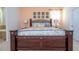 Ornate main bedroom boasting a decorative headboard and bedside tables with lamps at 2613 Santosh Cv, Kissimmee, FL 34746