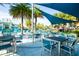 Community poolside lounge area featuring patio seating under sunshades with views of the splash park at 2613 Santosh Cv, Kissimmee, FL 34746