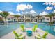 Resort style community pool with lounge chairs and ample space for relaxation under the blue sky at 2613 Santosh Cv, Kissimmee, FL 34746