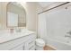 Bright bathroom with white cabinets, quartz countertop, large mirror, and tiled shower over tub at 2714 Forestdale St, St Cloud, FL 34771