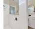 Modern bathroom with sleek tiles, glass shower partition, and an elegant mirror over a stylish vanity at 2714 Forestdale St, St Cloud, FL 34771