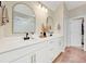 Elegant bathroom featuring double sinks, modern lighting, and stylish mirrors, creating a spa-like retreat at 2714 Forestdale St, St Cloud, FL 34771