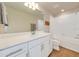 Bright bathroom with white cabinets, quartz countertop, large mirror, and tiled shower over tub at 2714 Forestdale St, St Cloud, FL 34771
