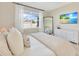 Cozy bedroom features a large window, TV, and a full-length mirror for optimal natural light and convenience at 2714 Forestdale St, St Cloud, FL 34771