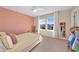 Bright bedroom featuring a full bed, ceiling fan, and natural light from the large window at 2714 Forestdale St, St Cloud, FL 34771