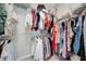 Organized walk-in closet filled with clothing, offering ample storage and easy access at 2714 Forestdale St, St Cloud, FL 34771