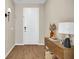 Inviting entryway featuring wood-look floors and a modern console table with decor at 2714 Forestdale St, St Cloud, FL 34771
