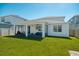 Rear exterior view of home features manicured lawn and screened in lanai with outdoor seating at 2714 Forestdale St, St Cloud, FL 34771