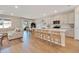 Bright open kitchen with white cabinetry, a large island, and wood-look flooring at 2714 Forestdale St, St Cloud, FL 34771