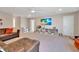 Spacious living room with a large TV, comfortable seating, and built in shelves for storage at 2714 Forestdale St, St Cloud, FL 34771
