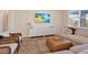 Inviting living room with beach-themed media, modern furniture, and a stylish ottoman on an area rug at 2714 Forestdale St, St Cloud, FL 34771