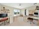 Bright home office with dual workstations, natural light, and modern decor at 2714 Forestdale St, St Cloud, FL 34771