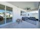 Covered patio with comfortable seating area, ceiling fan, and sliding glass doors to the interior at 2714 Forestdale St, St Cloud, FL 34771