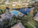 Overhead view of the community featuring the pool, pond with a fountain, walking paths, and lush landscaping at 2763 Metro Sevilla Dr # 108, Orlando, FL 32835