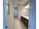 Spacious bathroom with double vanity, modern lighting, and a walk-in shower at 2765 Redblush Ter, St Cloud, FL 34772