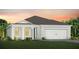 Charming single-story home with a two-car garage, well-manicured lawn, and tropical landscaping at 2765 Redblush Ter, St Cloud, FL 34772