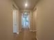 Long hallway with hardwood floors leading to various rooms, freshly painted in neutral colors at 2765 Redblush Ter, St Cloud, FL 34772