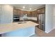 Modern kitchen with stainless steel appliances, a kitchen island, and wooden cabinets at 2765 Redblush Ter, St Cloud, FL 34772