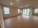 Bright living room featuring wood floors, multiple windows, and sliding glass doors to the backyard at 2765 Redblush Ter, St Cloud, FL 34772