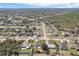 Wide aerial view of a peaceful neighborhood featuring diverse home styles and tree-lined streets at 2801 W Covington Dr, Deltona, FL 32738