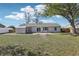 View of the back exterior of the house with a sliding door and a small patio at 2801 W Covington Dr, Deltona, FL 32738