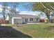View of the back exterior with a storage shed, sliding door, and manicured lawn at 2801 W Covington Dr, Deltona, FL 32738