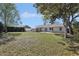 Expansive backyard with mature trees, a storage shed, and a brick patio at 2801 W Covington Dr, Deltona, FL 32738