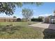 Large backyard featuring a fire pit, storage shed, and a wood fence at 2801 W Covington Dr, Deltona, FL 32738