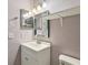 A bathroom showcasing a sink, toilet and an expansive mirror for enhanced usability at 2801 W Covington Dr, Deltona, FL 32738