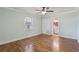 This bedroom features a window, wood flooring, and doorway to the bathroom at 2801 W Covington Dr, Deltona, FL 32738