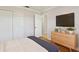A bedroom has a closet, light hardwood floors, a dresser, and neutral paint with white crown molding at 2801 W Covington Dr, Deltona, FL 32738