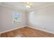 This bedroom features a ceiling fan, window, and wood flooring at 2801 W Covington Dr, Deltona, FL 32738