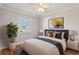 A well-lit bedroom with a window, plant, and framed wall art, complemented by natural light at 2801 W Covington Dr, Deltona, FL 32738